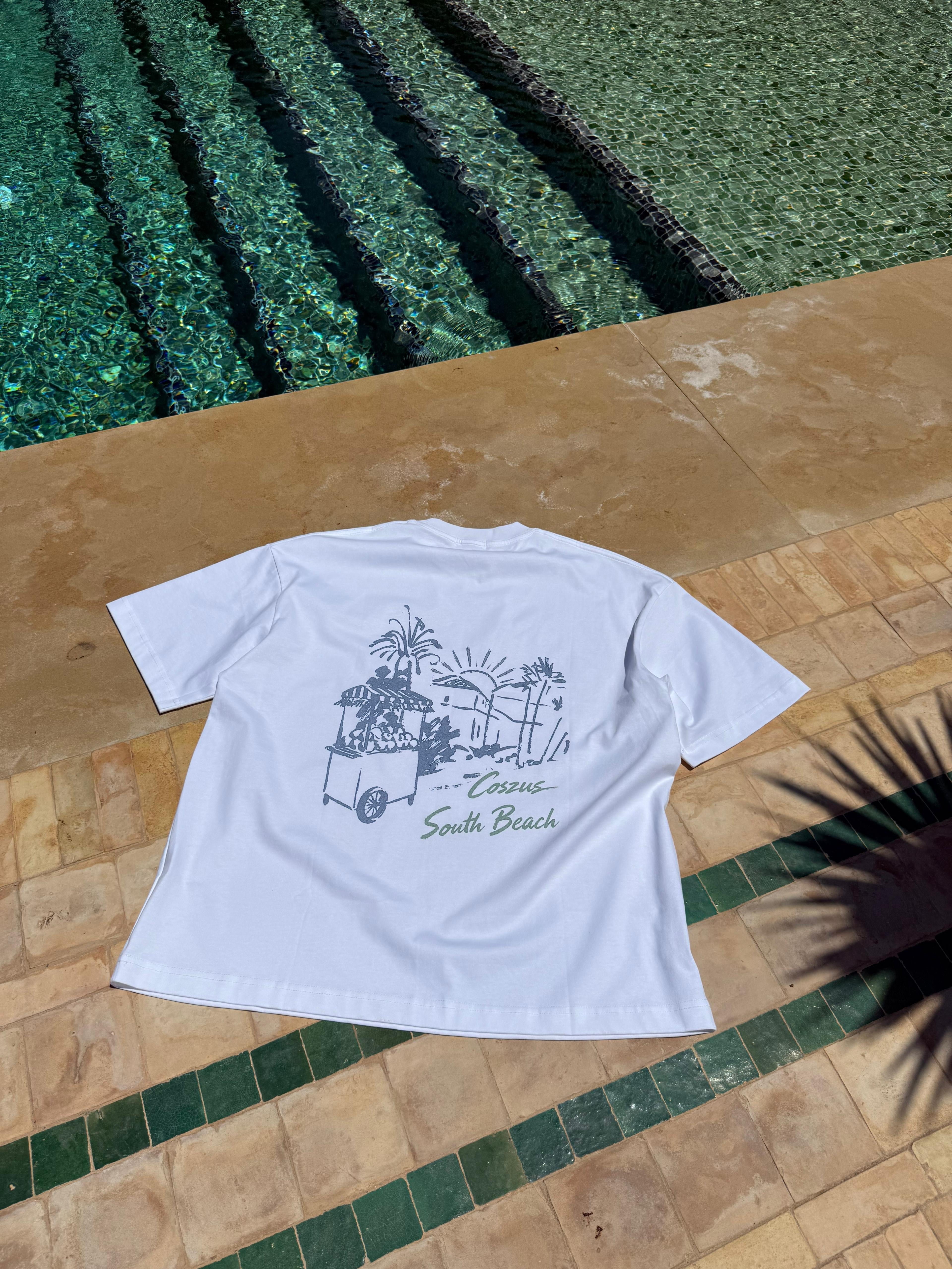 White t-shirt with graphic design on a tiled floor